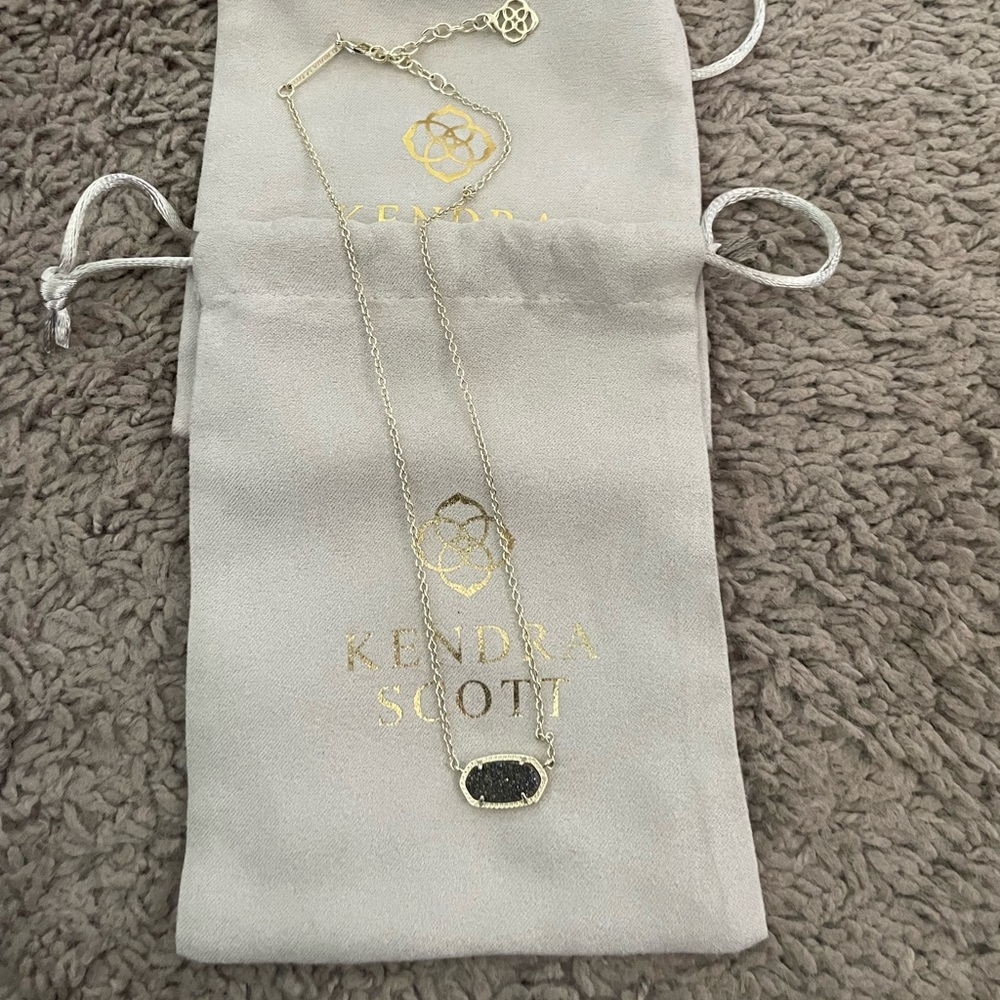Kendra Scott gold druzy necklace with black sparkly center.